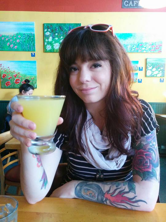 Shelby Dennis, your freelance beauty copwywriter, circa 2012. Drinking a mimosa and grinning at the camera.