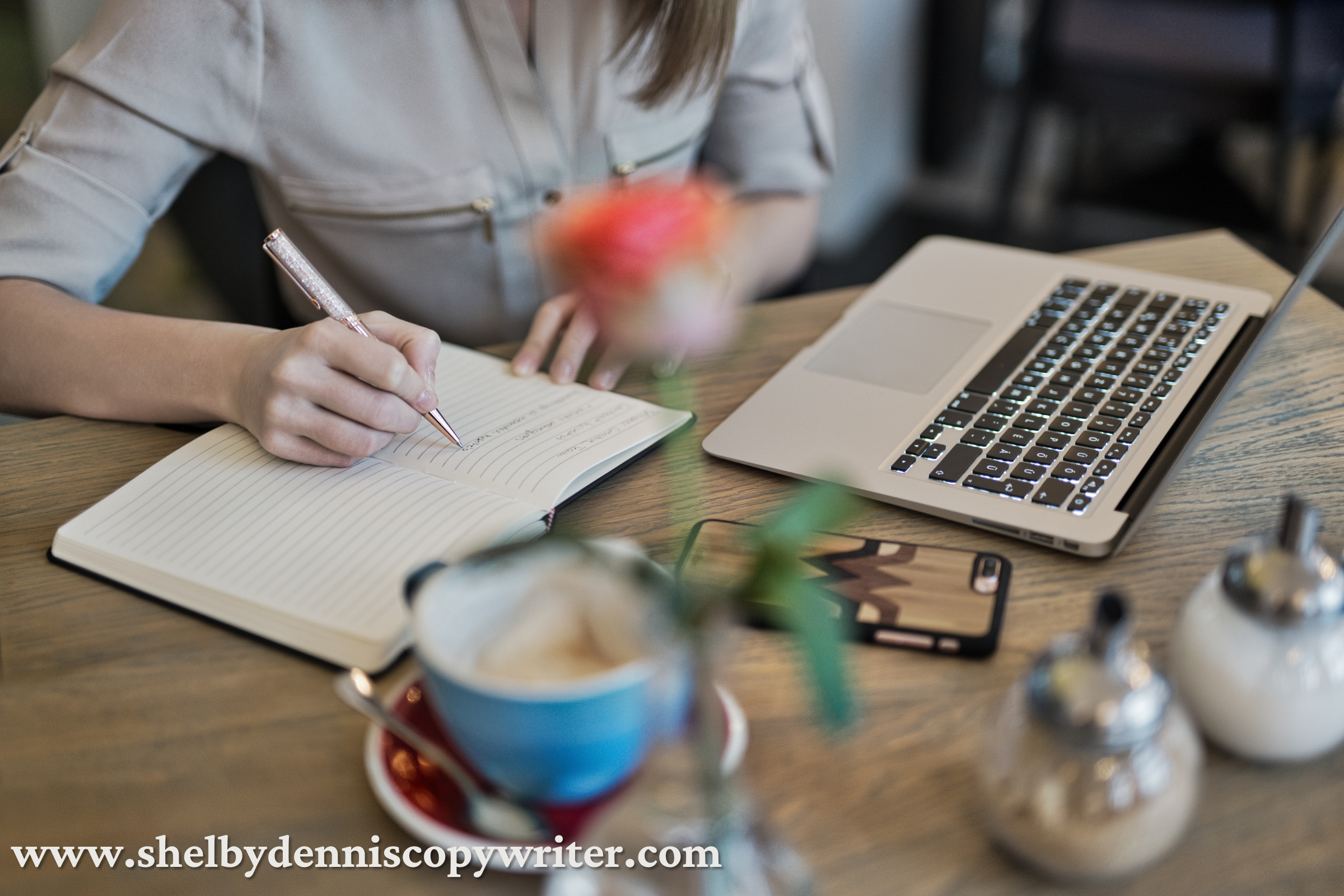 A freelance beauty copywriter at her desk, writing in a notebook.  A freelance beauty copywriter at her desk, writing in a notebook.