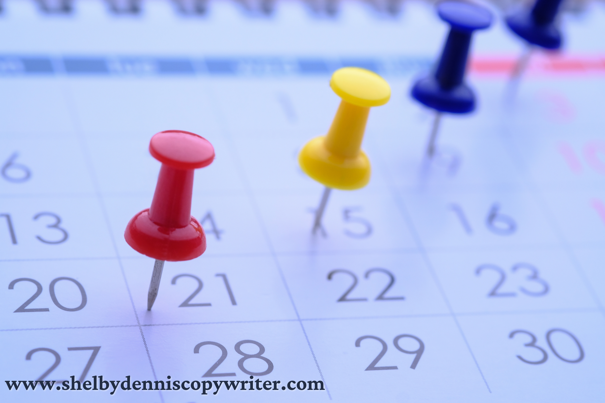 Thumbtacks stuck into deadline dates on a freelance beauty copywriter's calendar.  Thumbtacks stuck into deadline dates on a freelance beauty copywriter's calendar.