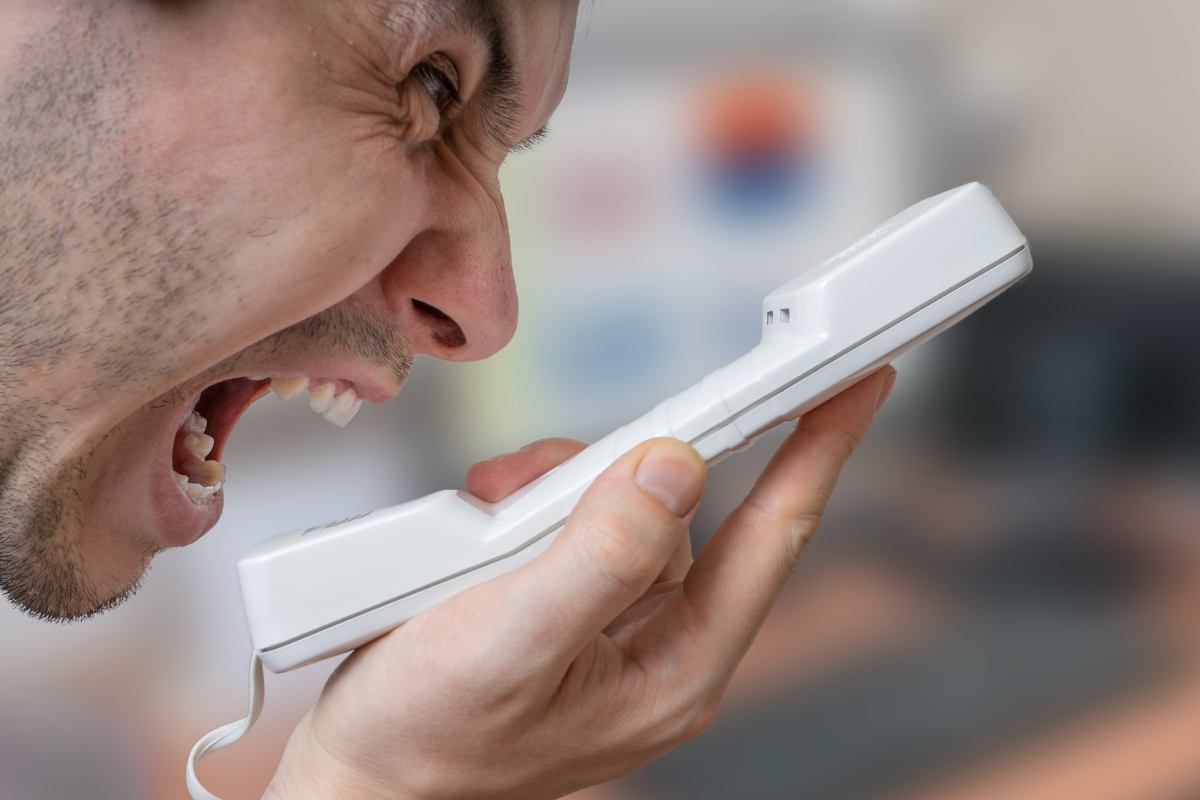 Man exhibiting a warning sign of a toxic client by blaming his freelance beauty copywriter via phone. Man exhibiting a warning sign of a toxic client by blaming his freelance beauty copywriter via phone.